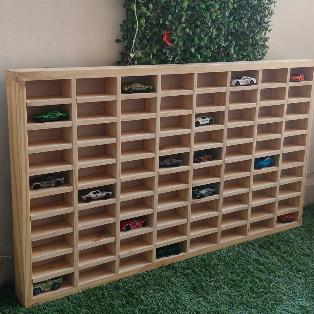 A wooden wall hanging storage unit for toy cars displayed on multiple shelves.